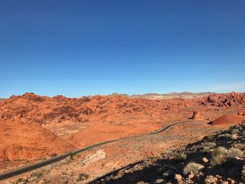 Scenic view of mountain against blue sky