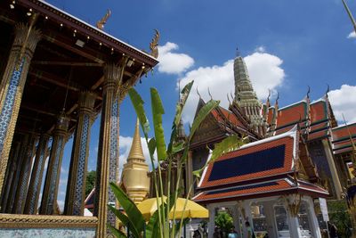 Low angle view of temple amidst buildings against sky