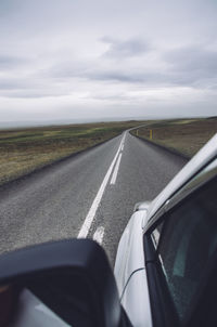 Road seen through car windshield against sky