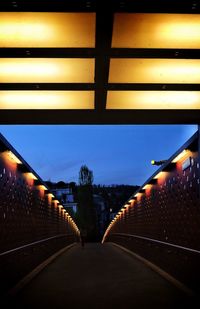 Illuminated tunnel at night