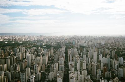 High angle view of modern buildings in city against sky