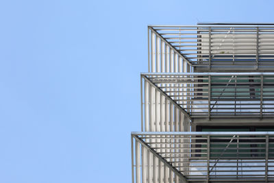 Low angle view of staircase against clear blue sky