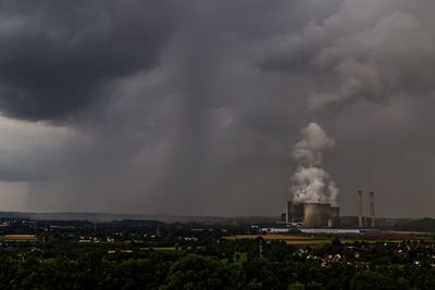 Coal burning energy plant against cloudy sky