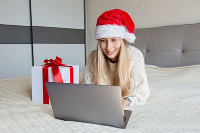 Happy woman celebrating friends with video call. christmas online holiday celebration, new year