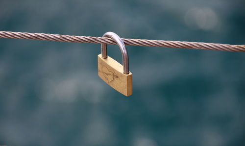 Close-up of padlocks hanging on metal