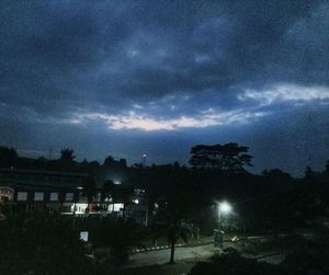 Illuminated city against sky at night