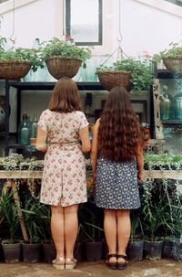 Rear view of women standing indoors