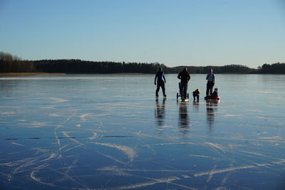 People ice-skating on frozen lake