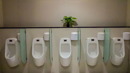 Close-up of urinals on wall