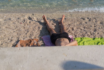 Young man sunbathing on beach in croatia