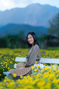 Portrait of a smiling young woman on field