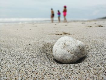 Close-up of sand on beach against sky