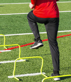 Low section of man exercising on grass