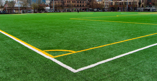 Soccer field and buildings in city