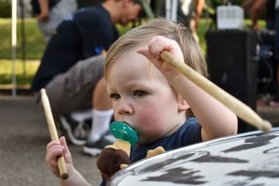 Close-up of boy sucking pacifier at playground