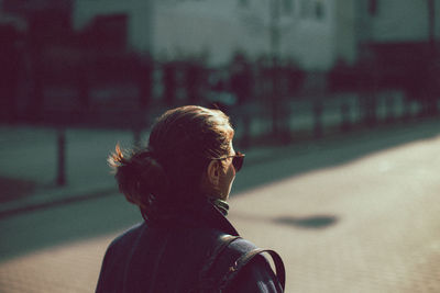 Rear view of man on street in city