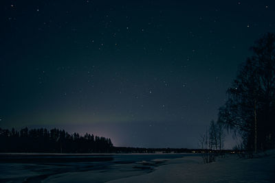 Scenic view of snow against sky at night