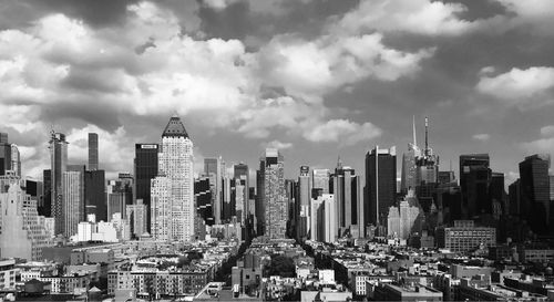 View of cityscape against cloudy sky