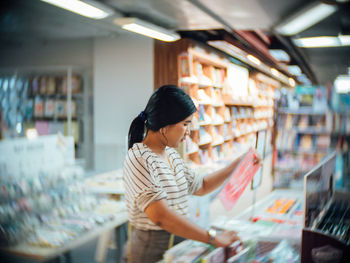 Rear view of woman standing in store