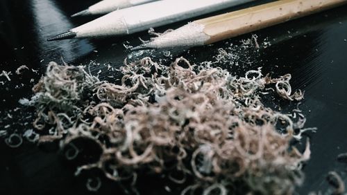 Close-up of pencils and shavings on table