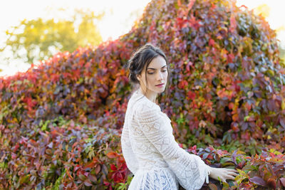 Beautiful young woman in a white lace blouse in an autumn park. summer or fall season 