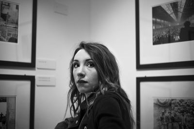 Portrait of young woman looking away at home