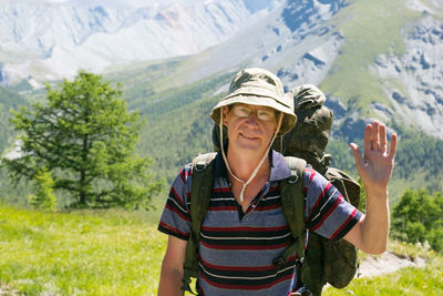 Portrait of smiling woman standing on mountain