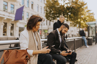 People sitting and using cell phones