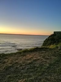 Scenic view of sea against clear sky during sunset