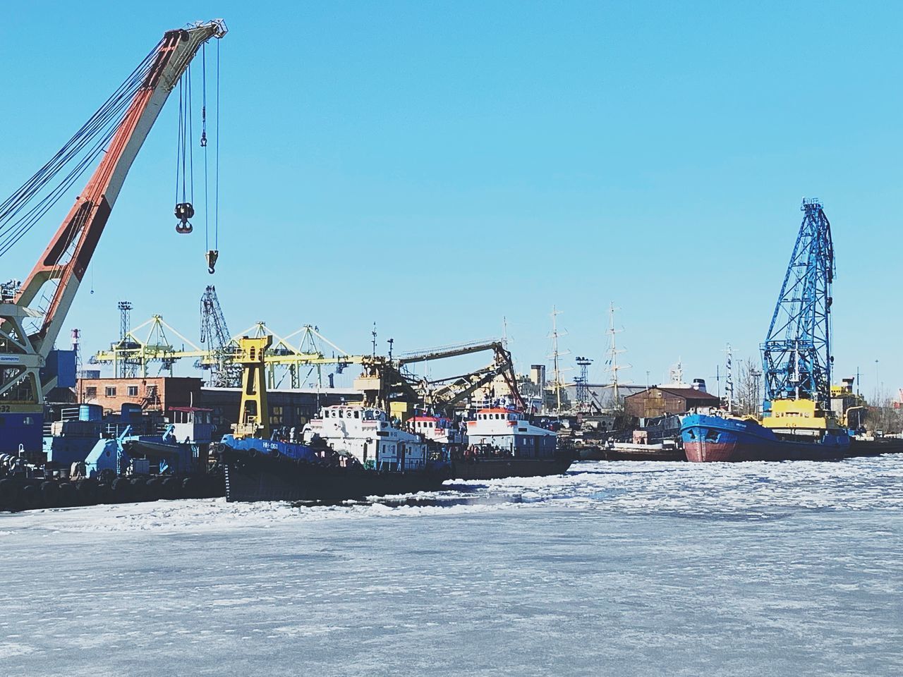 VIEW OF CRANES AGAINST SKY