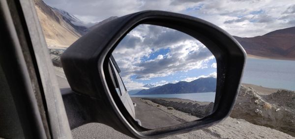 Scenic view of mountains seen through car window