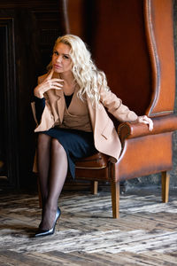 Young woman sitting on sofa at home