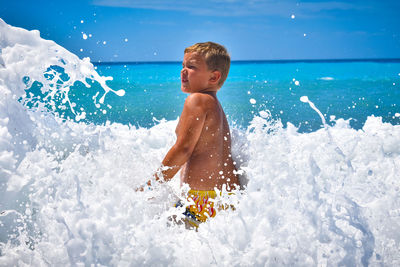 Full length of shirtless boy in swimming pool