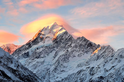 Scenic view of snowcapped mountains against sky during sunset