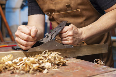 Midsection of man working in workshop