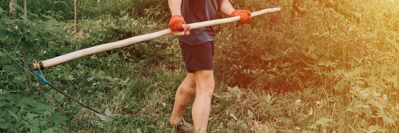 Low section of man working on field