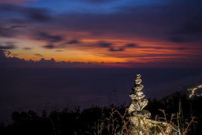 Silhouette statue against sky during sunset