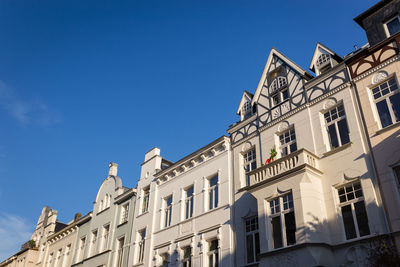 Low angle view of historic building against blue sky