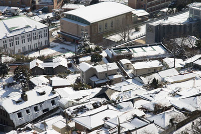 High angle view of snow covered buildings in city