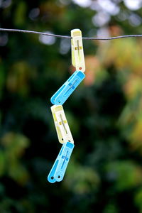 Clothespins hanging on clothesline