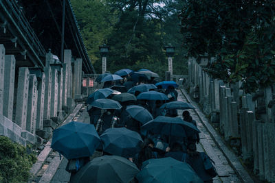 Teenagers with umbrellas on a school trip to nagoya