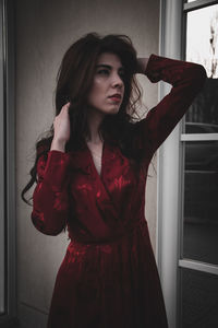 Portrait of beautiful young woman standing at home