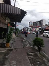 City street and buildings against sky