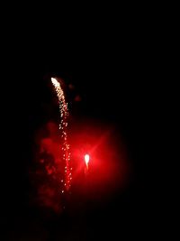 Low angle view of firework display at night