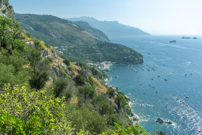 High angle view of sea and mountains against sky