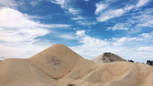 View of desert against cloudy sky