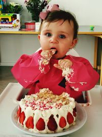 Portrait of cute girl with chocolate cake on table