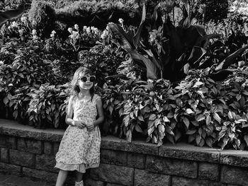 Girl standing by plants