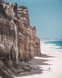 Scenic view of ocean against sky and huge beautiful rocks 