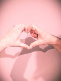 Close-up of hands making heart shape